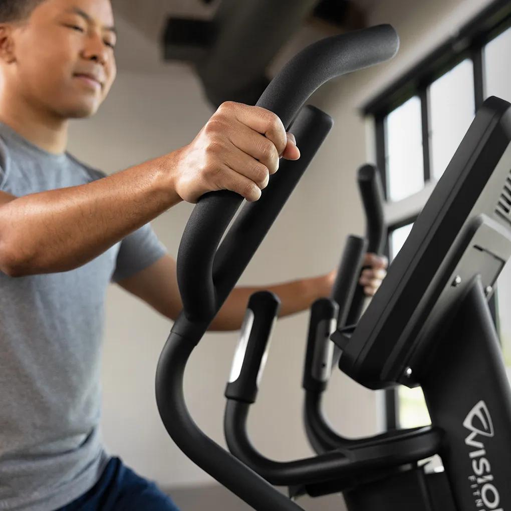 Close-up view of a person using the Summit Ascent Trainer, focusing on its handles.
