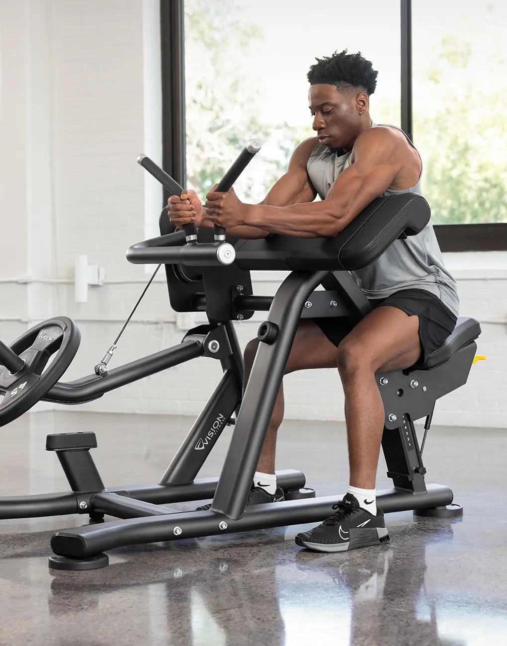 A person in black shorts with both hands gripping the rubber handles.