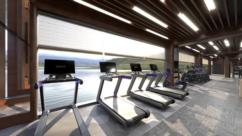 3D render of a high-end gym with cardio equipment facing the windows looking out at water