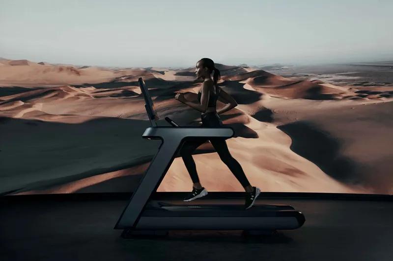 A person running on a Matrix Onyx treadmill with a desert landscape in the background