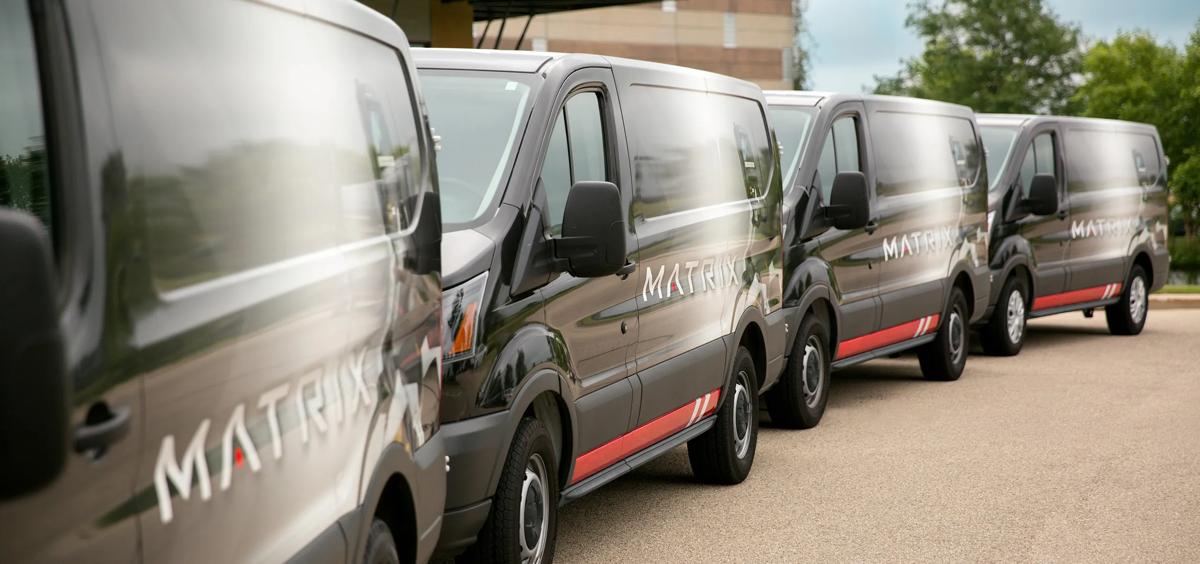 Row of Matrix service vans parked outside
