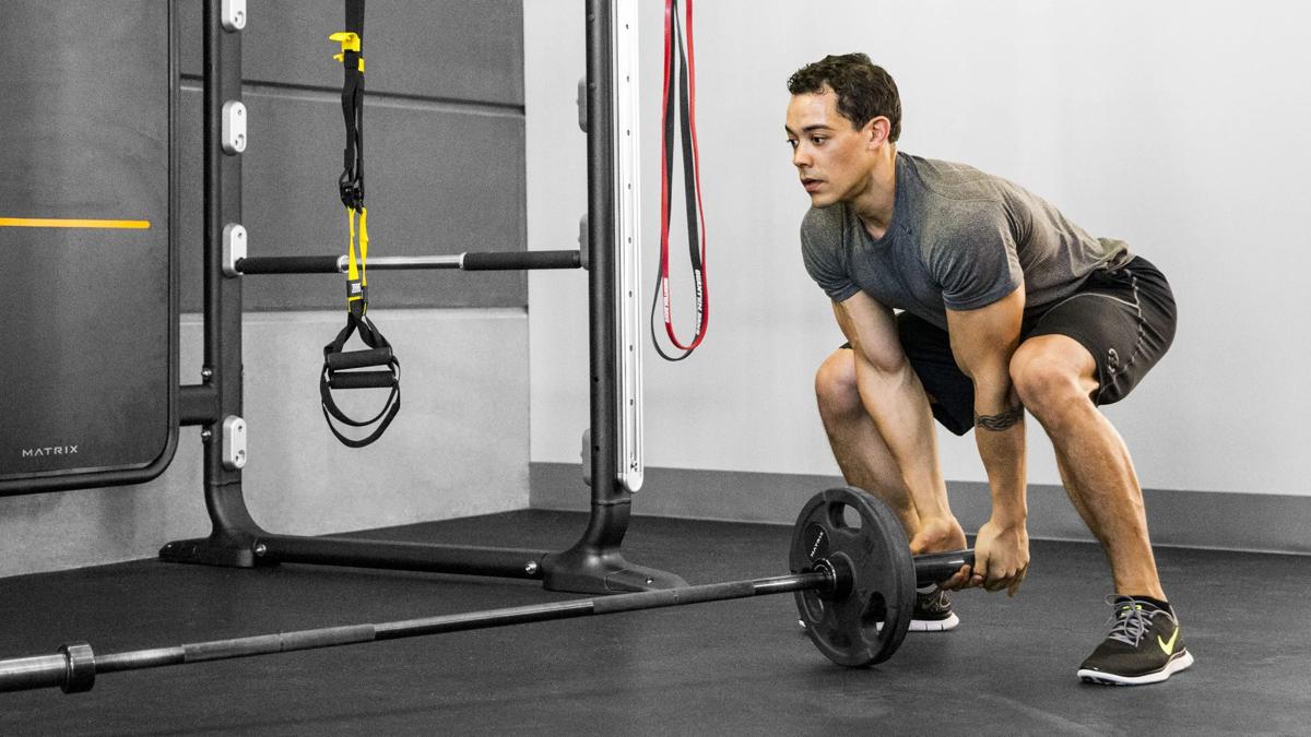 Man lifting barbell near Connexus