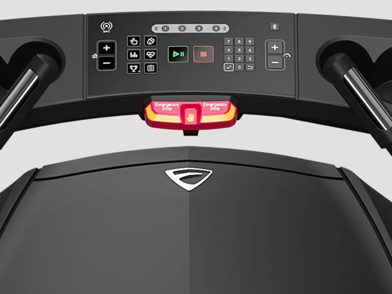 The Summit Treadmill viewed from the exerciser's perspective showing the controls, the handlebars and the emergency stop button.