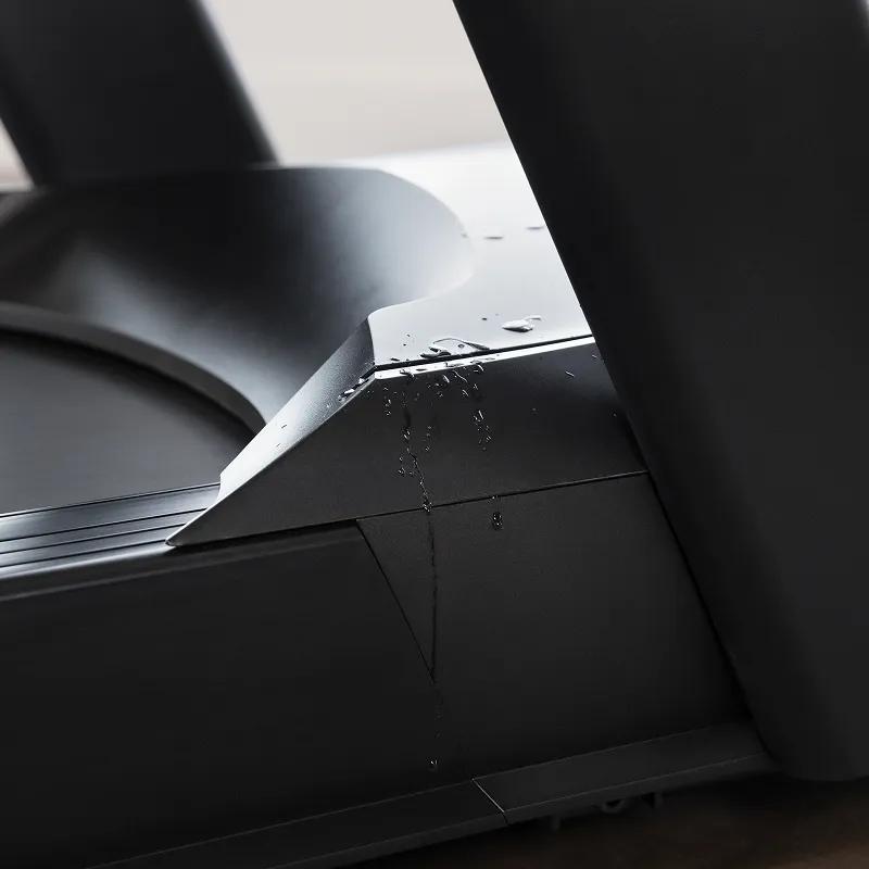 Close-up view of the Summit Treadmill with sweat on its case, protecting its drive system.