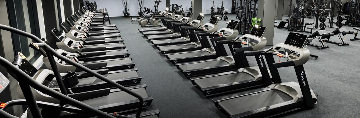 Interior view of Max Fitness Kolbenova, with several rows of Vision cardio and strength equipment.