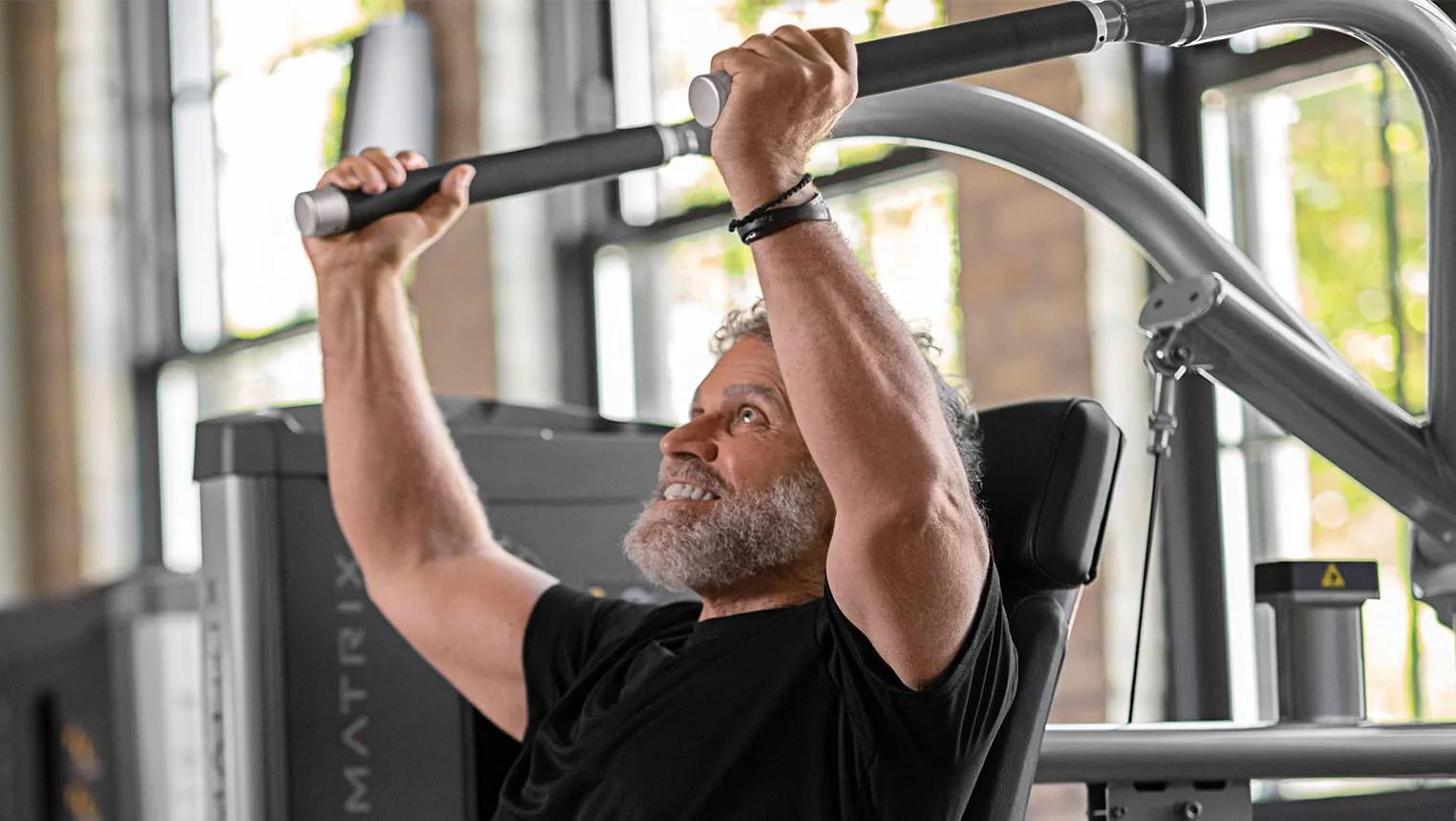 active aging man doing the shoulder press