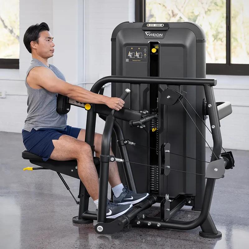 Person performing a seated row on the Keystone Diverging Seated Row machine, pulling the independent handles back with elbows bent and chest supported against the pad.