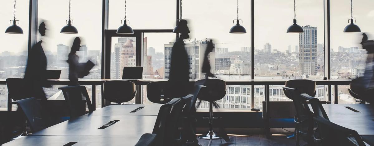 Corporate office with busy employees walking quickly from place to place.