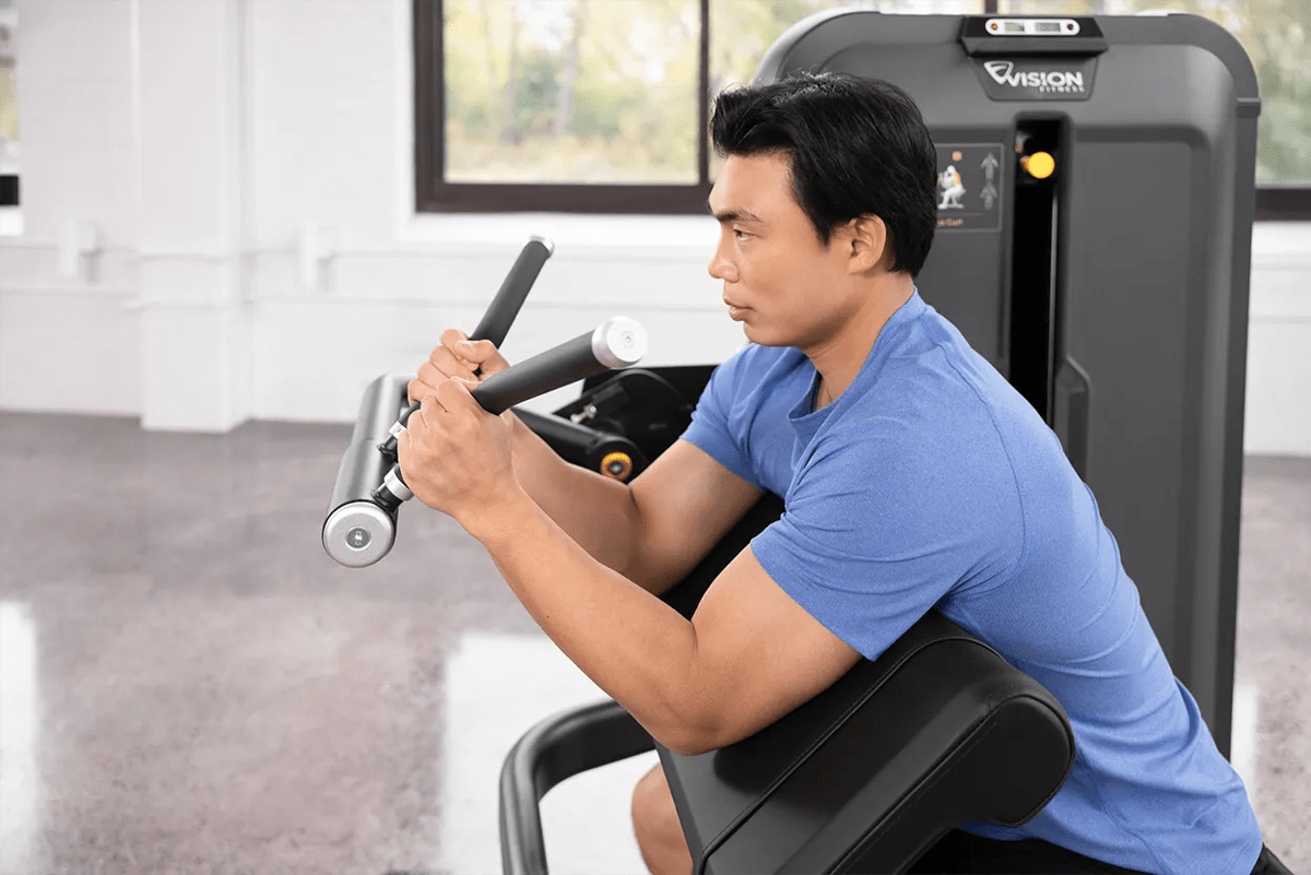 Man using Vision Keystone Biceps Curl in a gym.