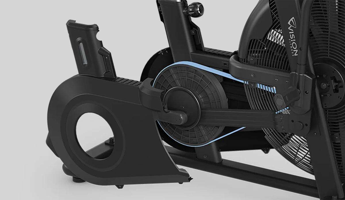 A close-up view of the AB700 Air Bike's belt drive system, featuring a large fan wheel and a protective casing partially removed to reveal the internal mechanism.