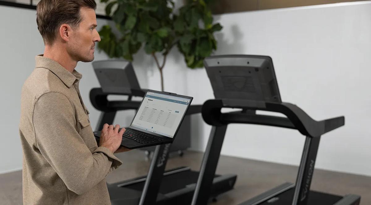 Fitness equiment manager uses Vision digital solutions platform on their laptop to track usage and support equipment performance.