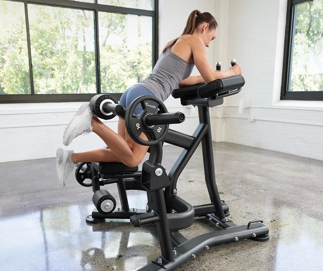 A person in blue shorts kneeling on the Vision Kneeling Leg Curl with their right leg bent with weights.