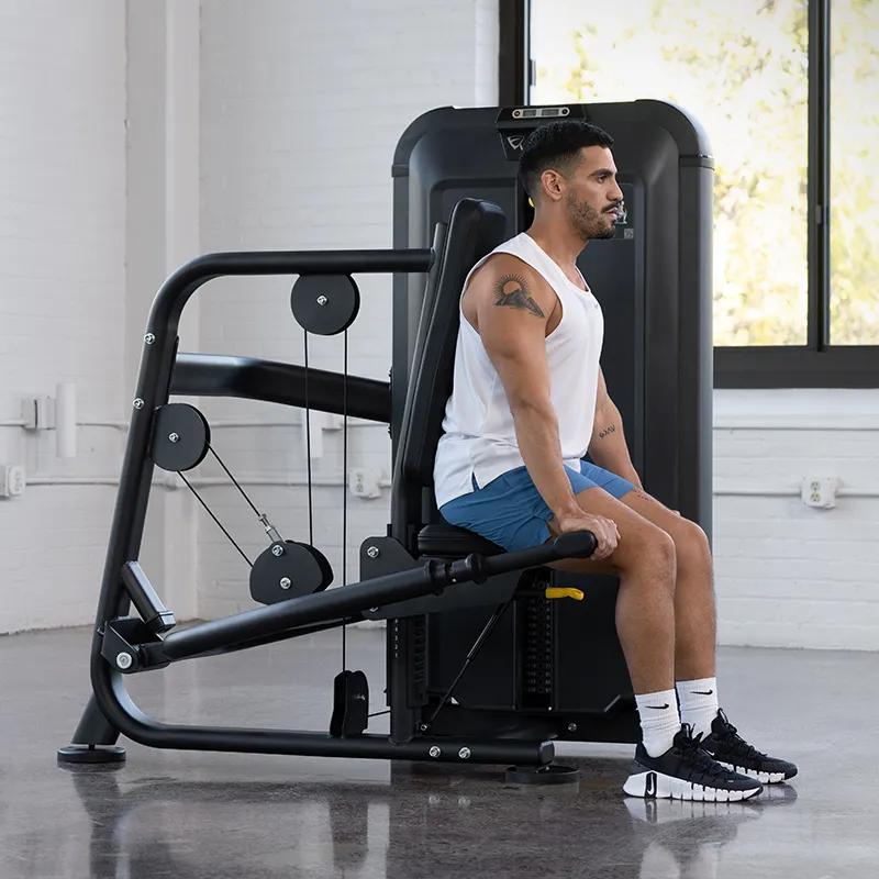 Side view of a man using the Keystone Triceps Press in a gym.