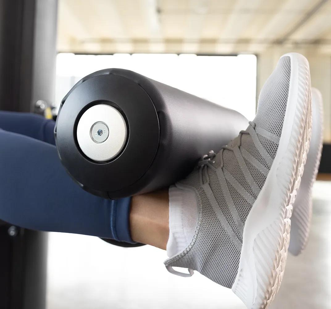 Close-up of the Keystone Leg Extension featuring its padded ankle roller and support frame.
