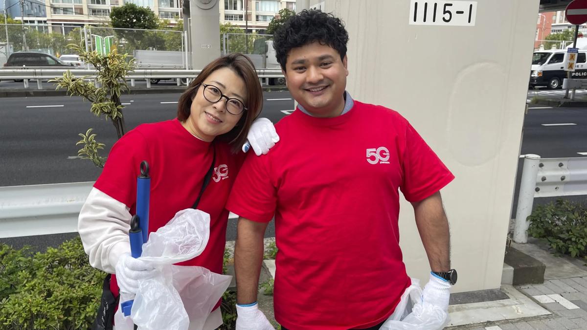 Two people smiling while one person rests their arm on the other.