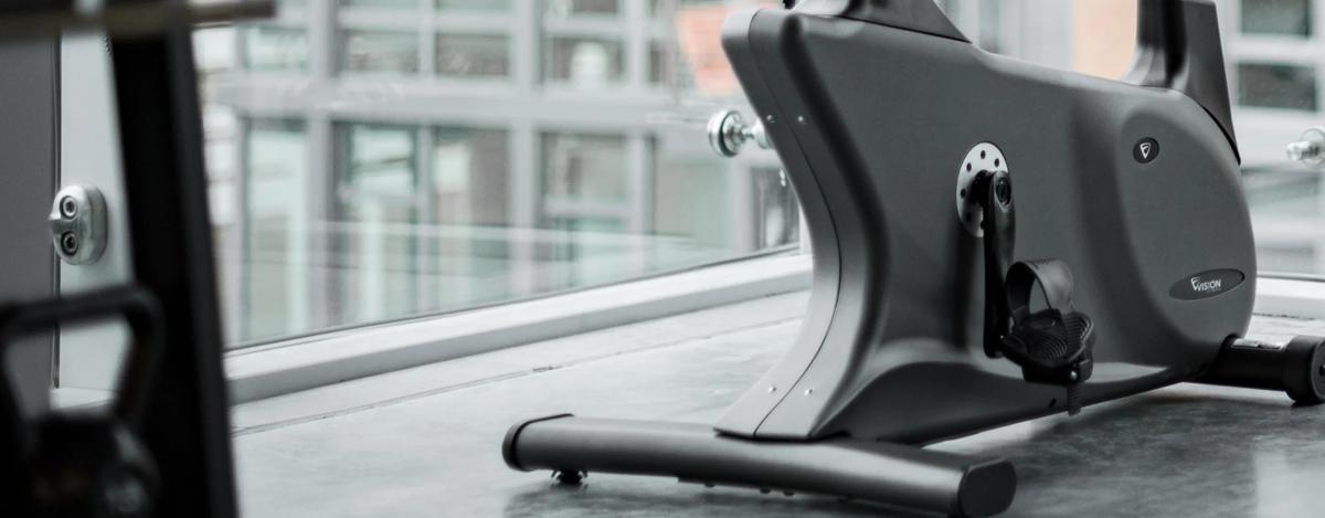 Close-up of the Upright Bike positioned near a large window with a cityscape in the background.